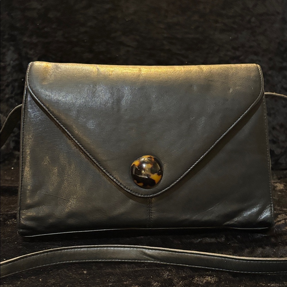 Chic Black Leather Clutch with Tortoiseshell Accent